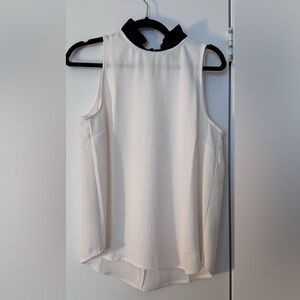 Elegant Cream Sleeveless Top with Black Ruffle Neckline